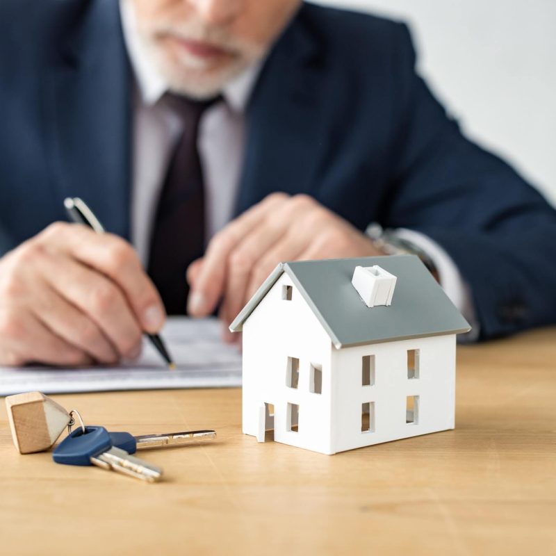 selective-focus-of-house-model-near-keys-and-house-dealer.jpg